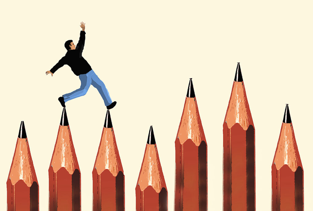 Ein Mann balanciert über überdimensionale Bleistiftspitzen. Die Illustration veranschaulicht den schwierigen Schreibprozess.